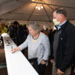 a person signs a steel beam for the student center at ɫƵ