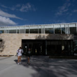 Two students walk outside the front of the Lowry Student Center at ɫƵ.