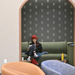 A student studying in the green theme room on the second floor of Lowry Center at ɫƵ.